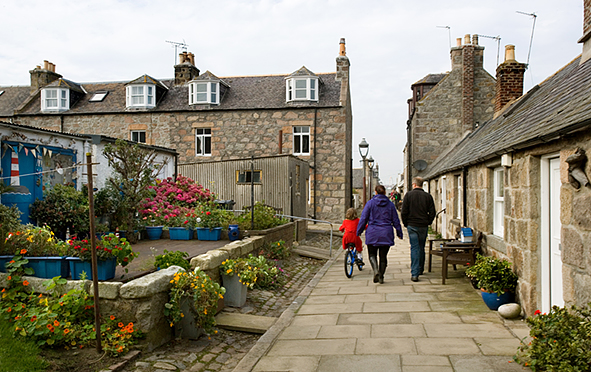 Families wander through the peaceful old Foot Dee fishing community. (Photo: Paul Tomins)