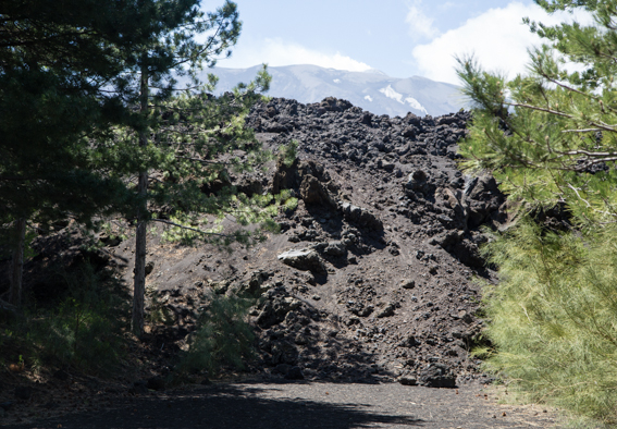Lava blocks a road on Etna with the peak smoking in the distance (Photo: Chris Allsop)