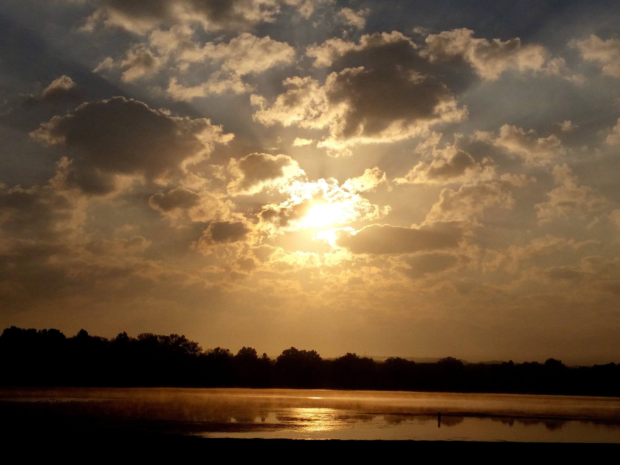 A dramatic sunset over a lake in Cortland