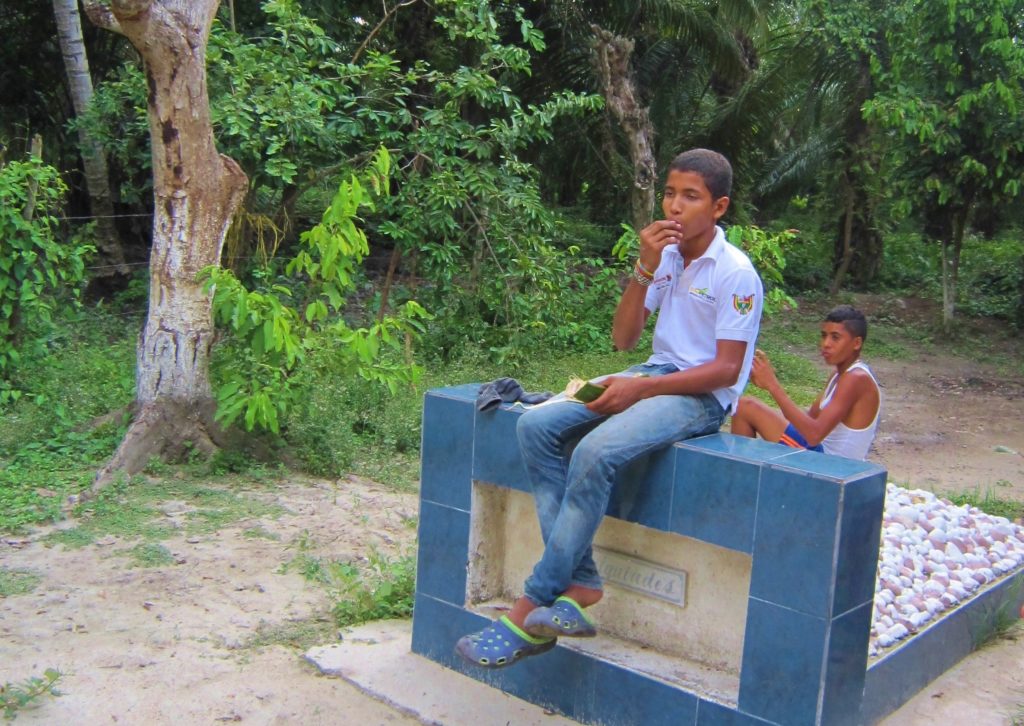 Local teenagers sitting on Melquiades' grave, Aracataca (Photo: Stephen Woodman)