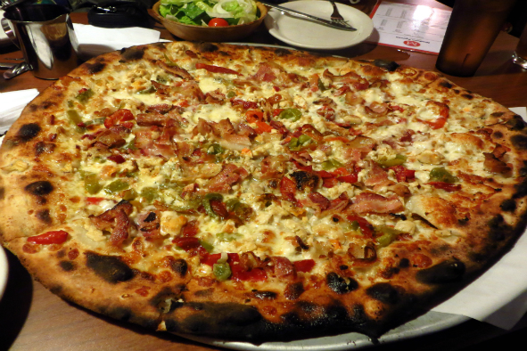 Modern Apizza's Clam Casino white pizza topped with mozzarella, clams, bacon, sweet green and red peppers, and white sauce (Photo: Libsciterp via Flickr)