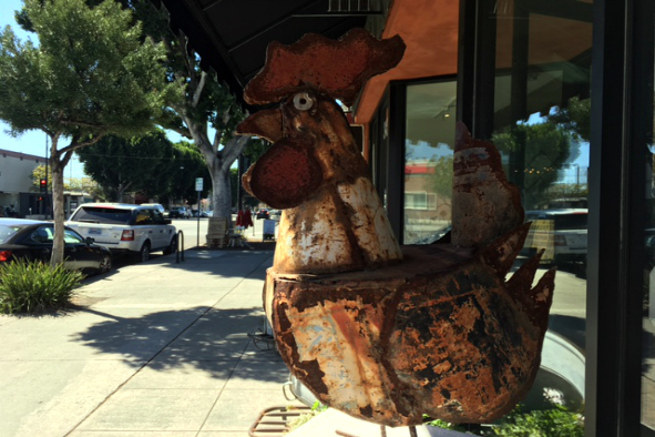 A vintage metal rooster sculpture stands watch outside Scavengers Paradise (Photo: Wendy Fontaine)
