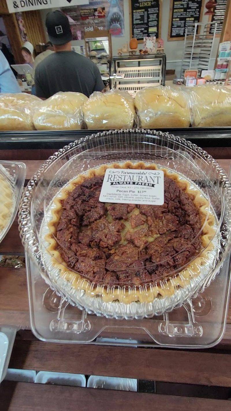 A Bakery Counter Stacked With Pies, Cookies, And Cheesecake