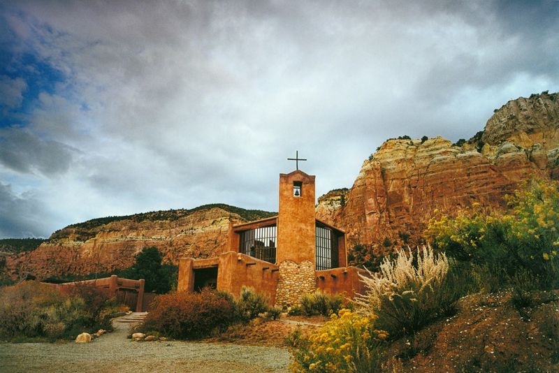 Sunlit Adobe Against Desert Cliffs