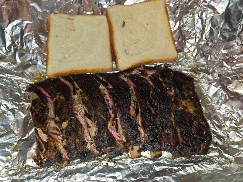 Ribs Are Served In Foil On Newspaper