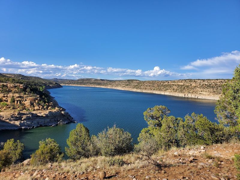 Blue Water Beneath Red Cliffs