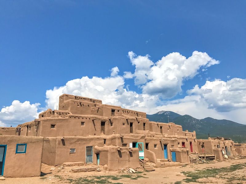 Sunbaked Adobe Towers Beneath Snowcapped Peaks