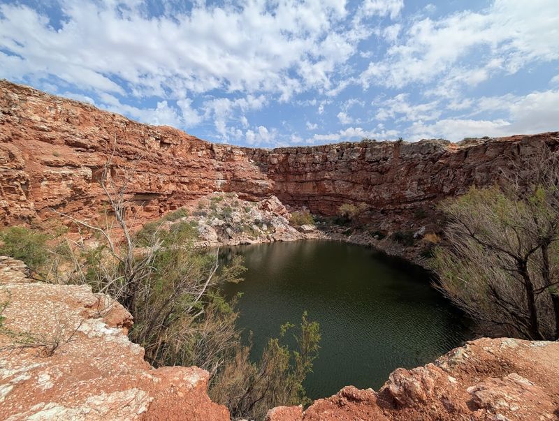 Turquoise Water Beneath Red Bluffs