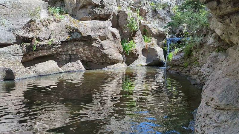 Clear Water Beneath Red Cliffs