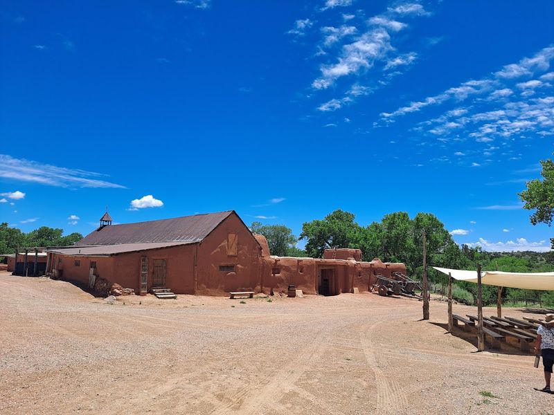 Sunlit Adobe Buildings Across The Ranch Grounds
