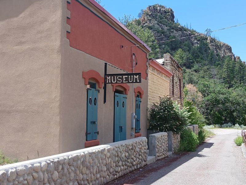 Sunlit Adobe Walls And Weathered Timber