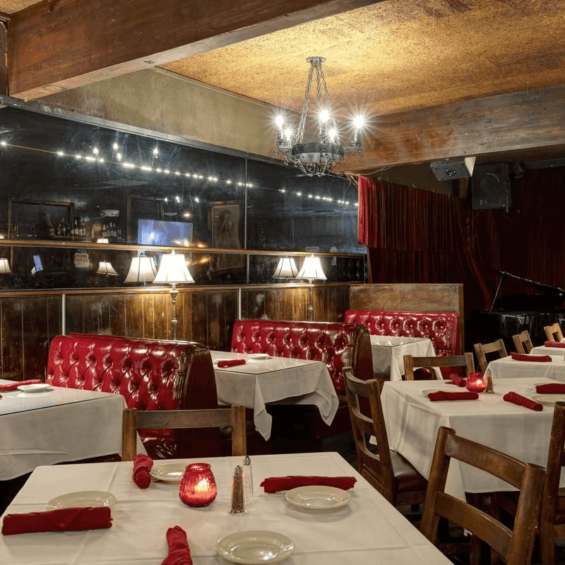 Red Booths, Wood Paneling, And A Room That Knows What It Is