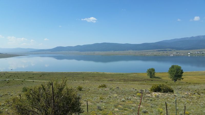 Blue Water Ringed By Dramatic Mountain Views