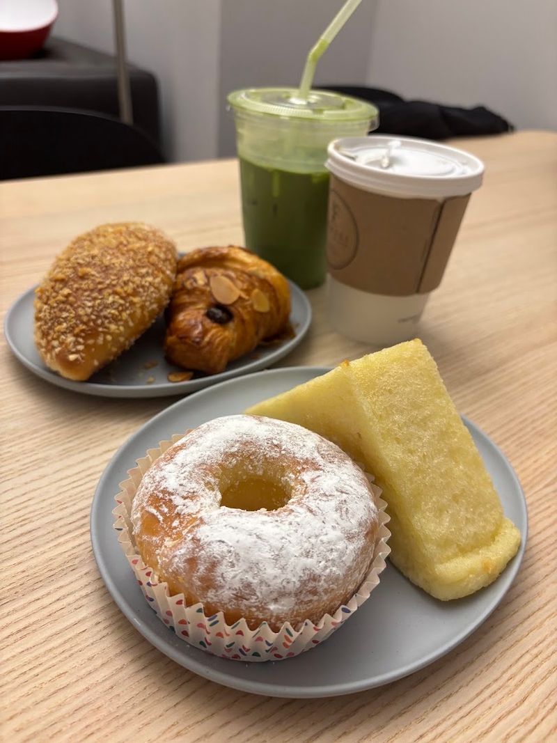 Baked Donuts And Almond Pastries Dress Up The Display