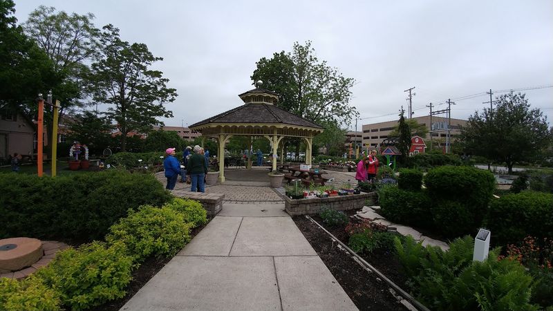 History Hides Between Flowers And Topiary