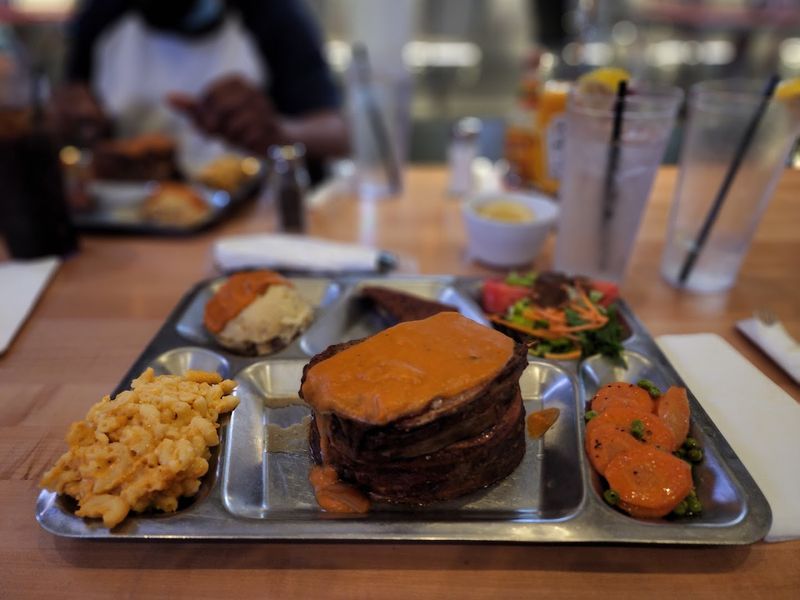 The Big Pink TV Dinner Arrives On A Stainless-Steel Tray