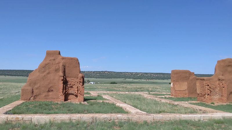 Brick Chimneys Rising From A Quiet Frontier Landscape