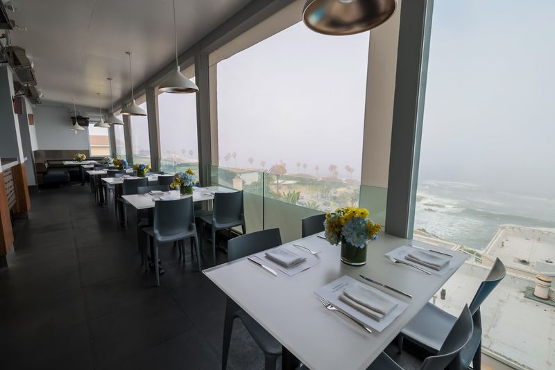Glass-Railing Tables Put The Coast Front And Center