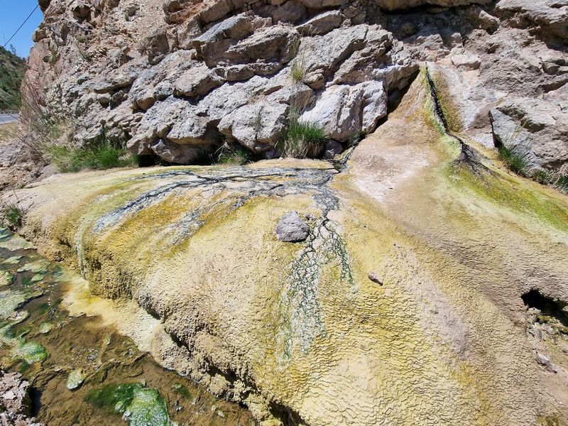 Ancient Mineral Layers Glow Beside The Road