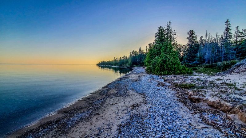 Lake Huron Appears Beyond The Forest