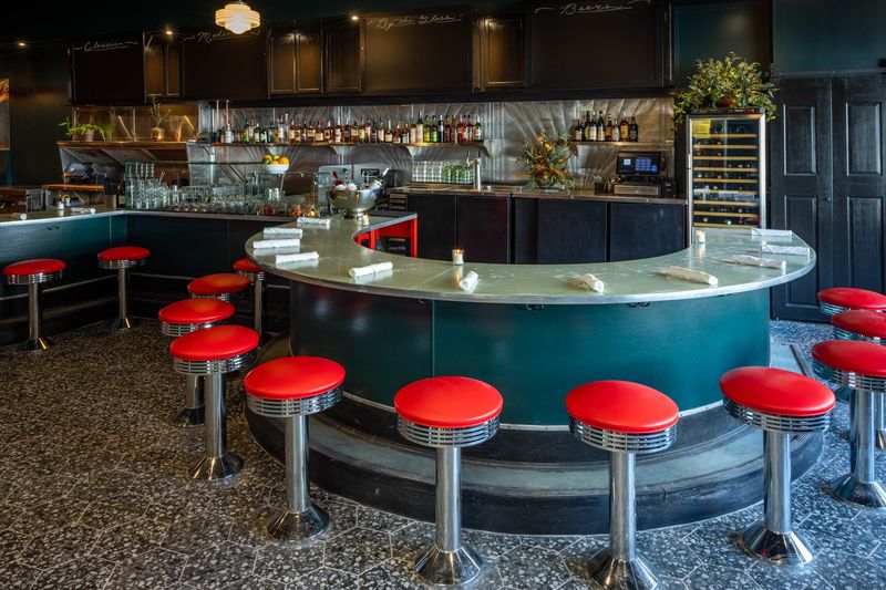 Red Stools, Warm Vibes, and Two Distinct Rooms