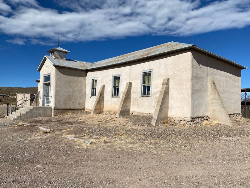 Empty Buildings Stand Against Vast Desert Skies