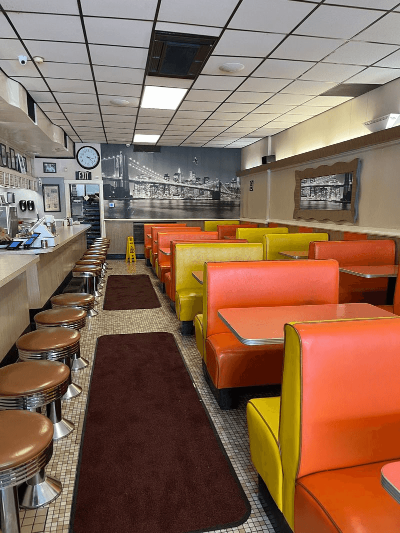 Neon, Booths, And A Griddle Front And Center