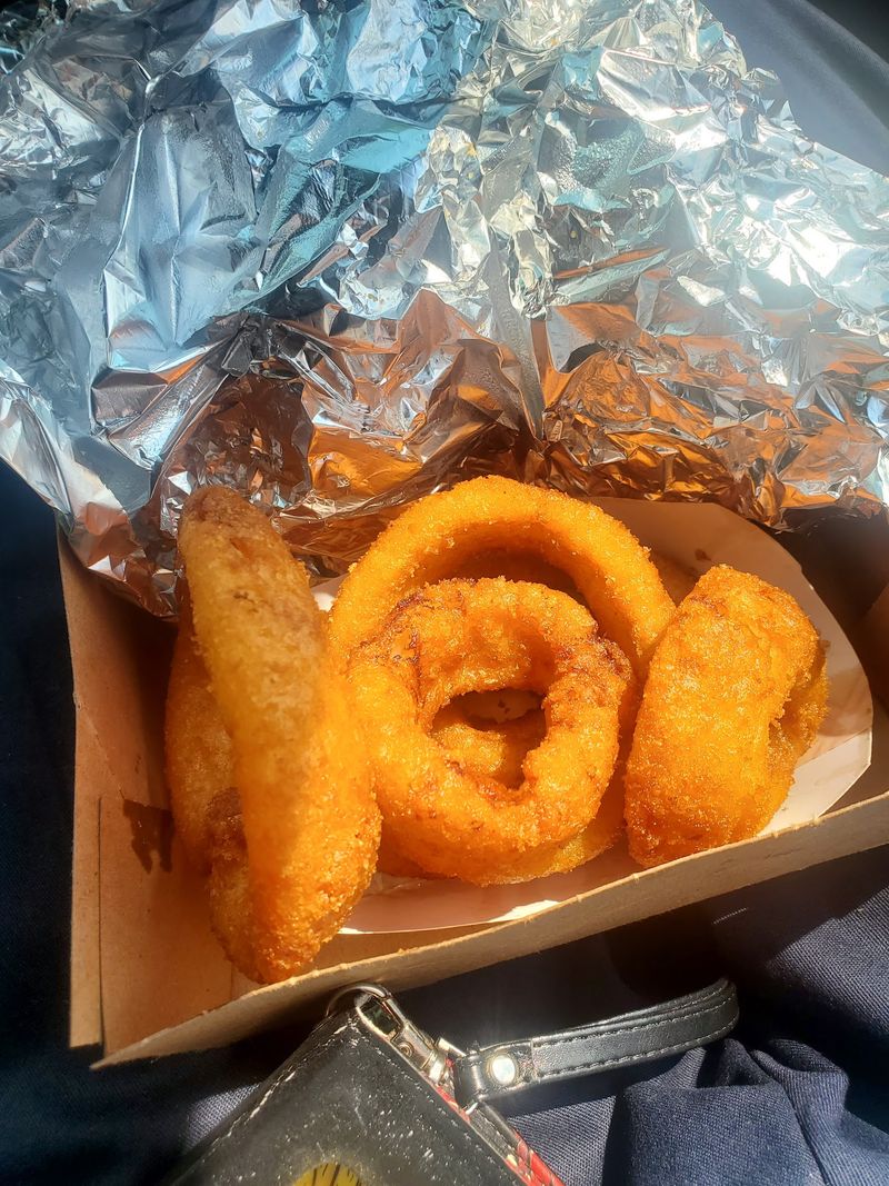 Huge Onion Rings And A Basket Of Crispy Sides