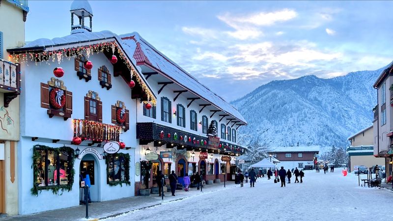 Snow-Covered Mountains And Bavarian Architecture Create A Storybook Winter Setting
