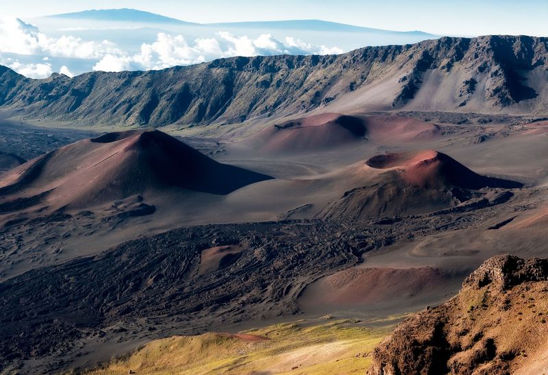 Red Cinder Cones And Ancient Lava Formations Fill The Vast Summit Depression