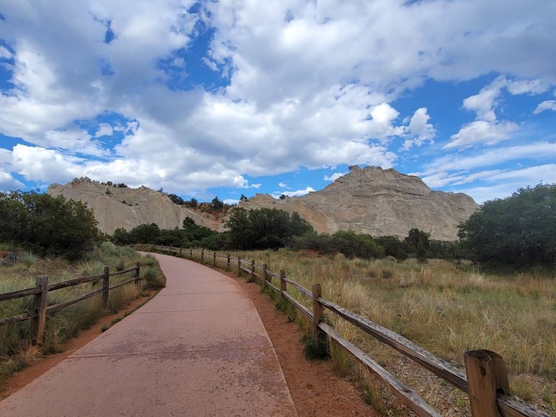 Paved Paths Wind Between Massive Rocks In Central Garden