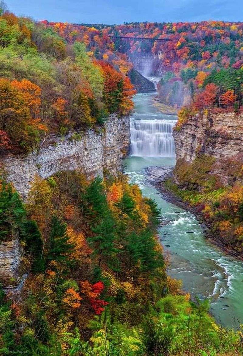 A River Gorge Wrapped In Red, Gold, And Orange