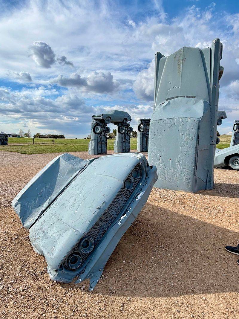 Some Cars Stand Upright While Others Balance Above Them