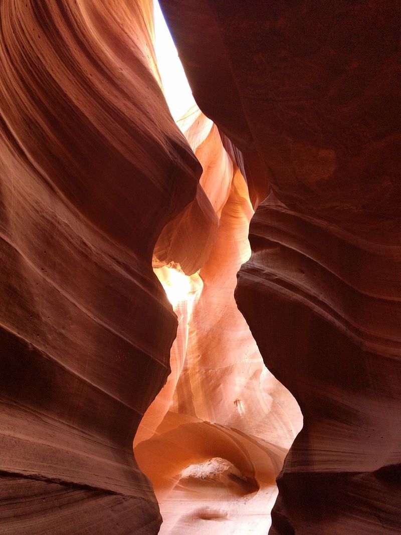 Narrow Sandstone Walls Shift From Gold To Orange And Pink