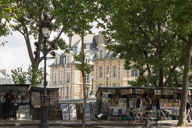 The bouquinistes sit against the grand buildings of Paris (Image by BikerNormand on Flickr)