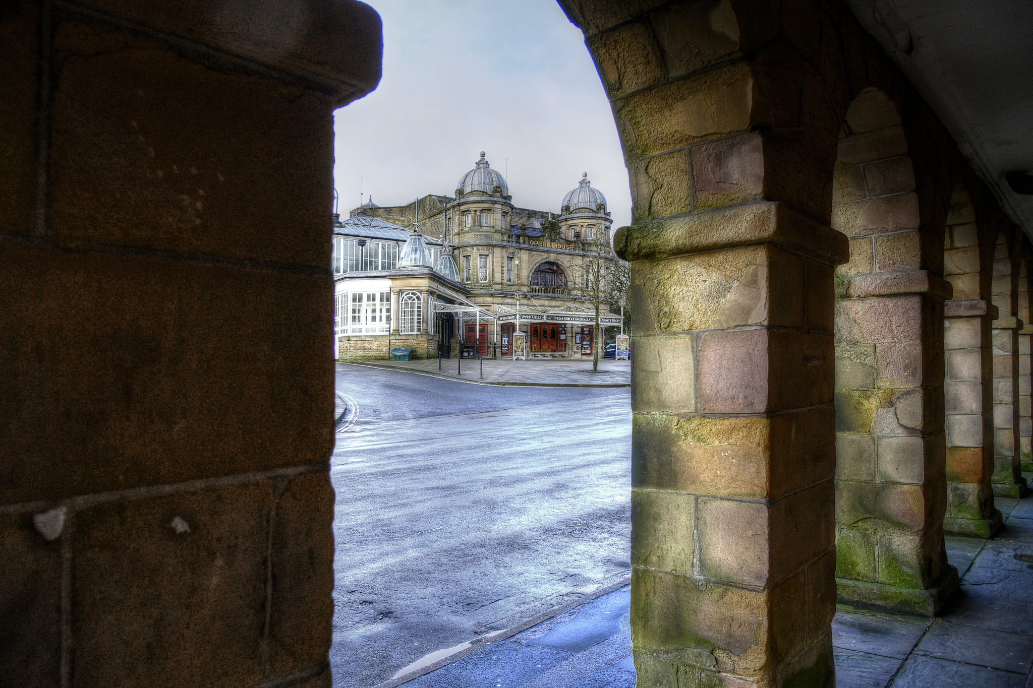 A view of Buxton Opera House from behind the arches on The Square