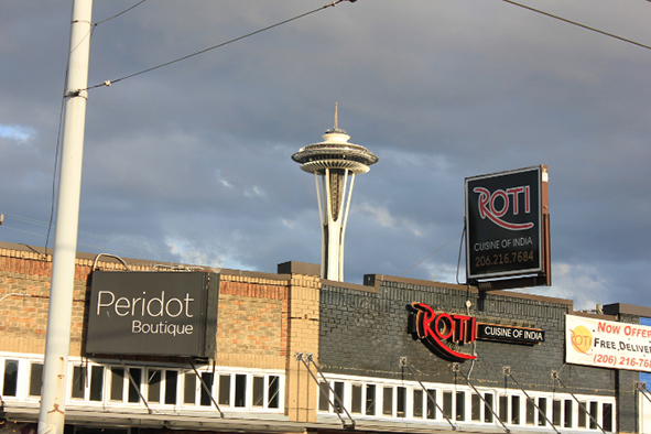 The Space Needle looming over nearby businesses (Photo: Jeffrey Rindskopf)