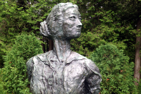 Robert G. Willis' seven-foot tall bronze statue depicts Edna St. Vincent Millay holding a book behind her back. The statue was installed in 1989 in Camden's Harbor Park (Photo: Janine Weisman)