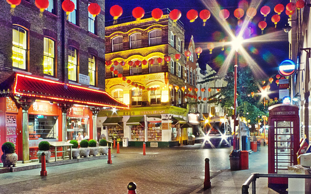 An iconic red London phone box cuts an isolated figure in the city's Chinatown late at night (Photo: Gert Jan Kole via Flickr)