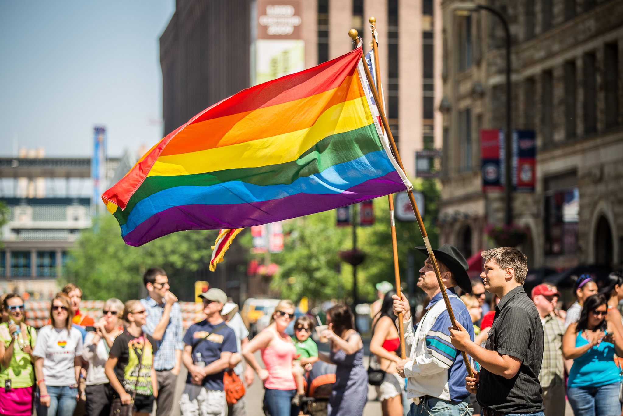 A festival-goer waves a rainbow flag at Twin Cities Pride (Photo: Tony Webs...